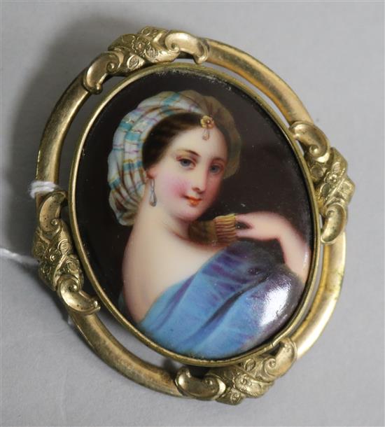 A late 19th century pinchbeck mounted oval porcelain portrait miniature, 62mm.